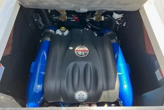 Slide: The Image of 2022 MasterCraft XStar S engine compartment with Ilmor engine, showcasing blue and black components. - 18