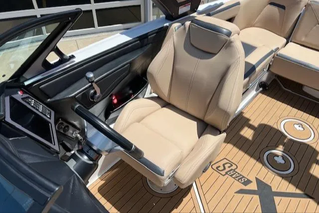 Slide: The Image of 2022 MasterCraft XStar S boat interior with beige seating and modern dashboard. - 21