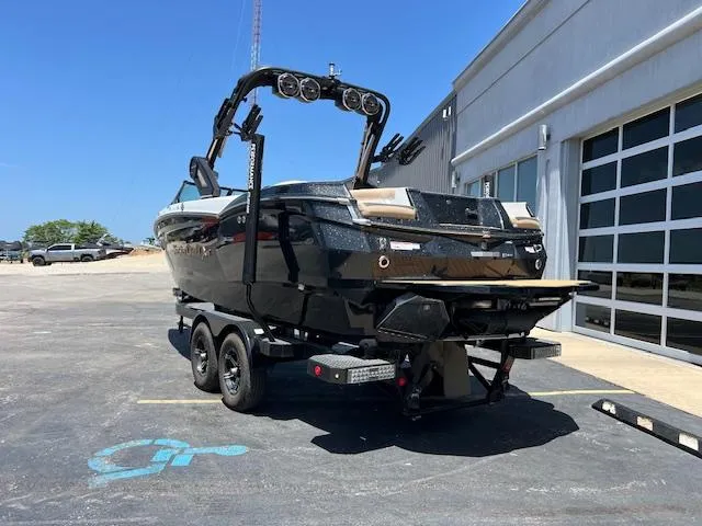 Slide: The Image of 2022 MasterCraft XStar S boat on trailer, parked outside a building. - 3