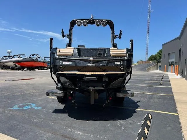 Slide: The Image of 2022 MasterCraft XStar S boat, rear view, parked outdoors on a sunny day. - 4