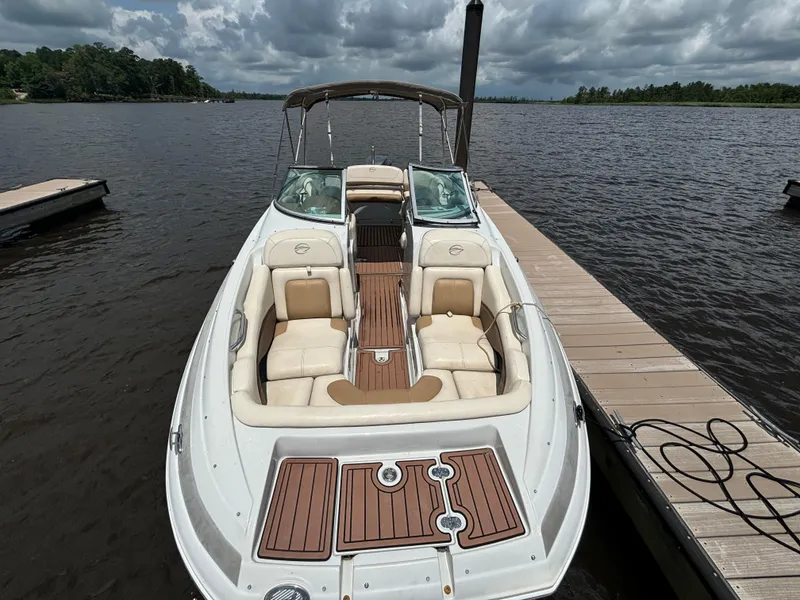 Slide: The Image of 2016 Crownline E4 boat docked on a lake under cloudy skies. - 10