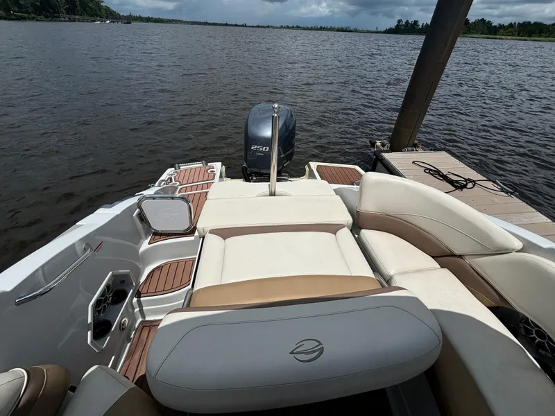 Slide: The Image of 2016 Crownline E4 boat with seating, docked on a calm lake. - 14