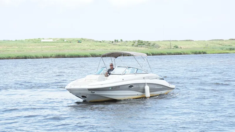 Slide: The Image of 2016 Crownline E4 boat cruising on a river with grassy banks. - 6