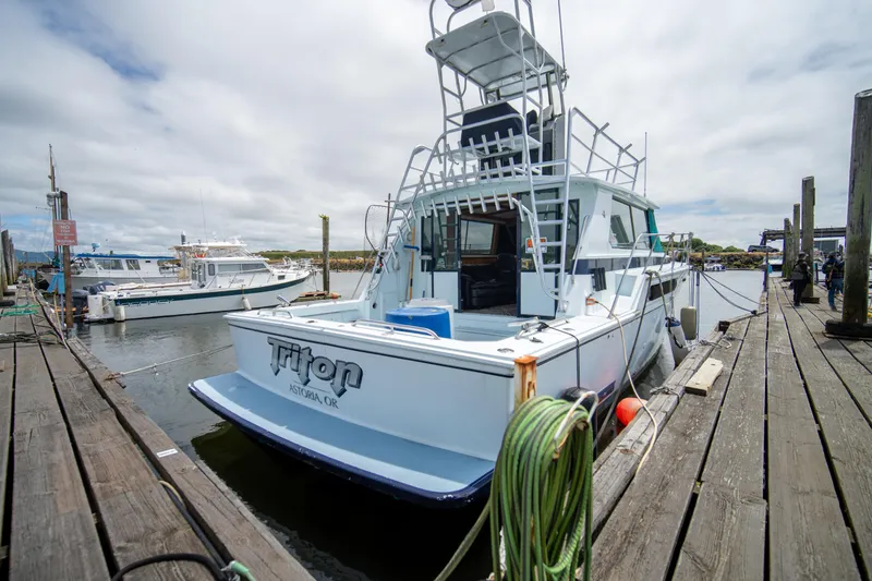 Slide: The Image of 1976 Bertram 42 Convertible boat docked at a marina in Astoria, Oregon. - 14
