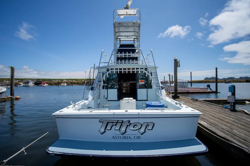 Slide: The Image of 1976 Bertram 42 Convertible boat docked in Astoria, Oregon under a clear blue sky. - 20