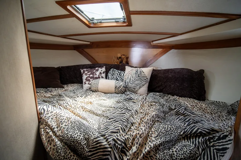 Slide: The Image of Cozy cabin interior of 1976 Bertram 42 Convertible with animal print bedding. - 8