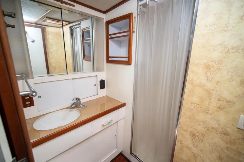 Slide: The Image of 1976 Bertram 42 Convertible bathroom with sink, mirror, and shower. - 9