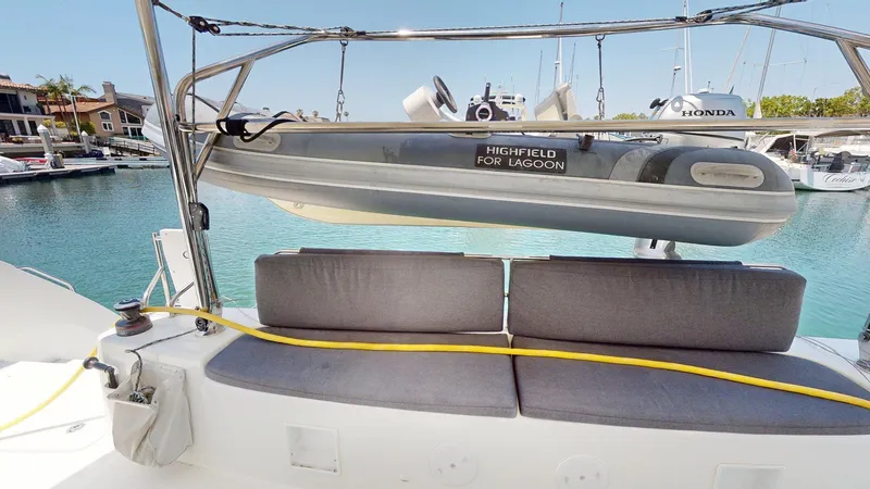 Slide: The Image of Catamaran Lagoon 46 (2020) with Highfield tender, docked in a marina. - 11