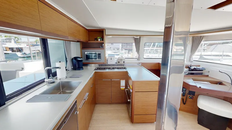 Slide: The Image of Modern kitchen interior of 2020 Lagoon 46 yacht with wood cabinetry and stainless steel appliances. - 15
