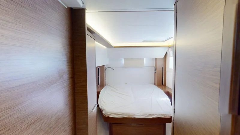 Slide: The Image of Interior cabin of 2020 Lagoon 46 yacht with modern wood finish and cozy bed. - 19