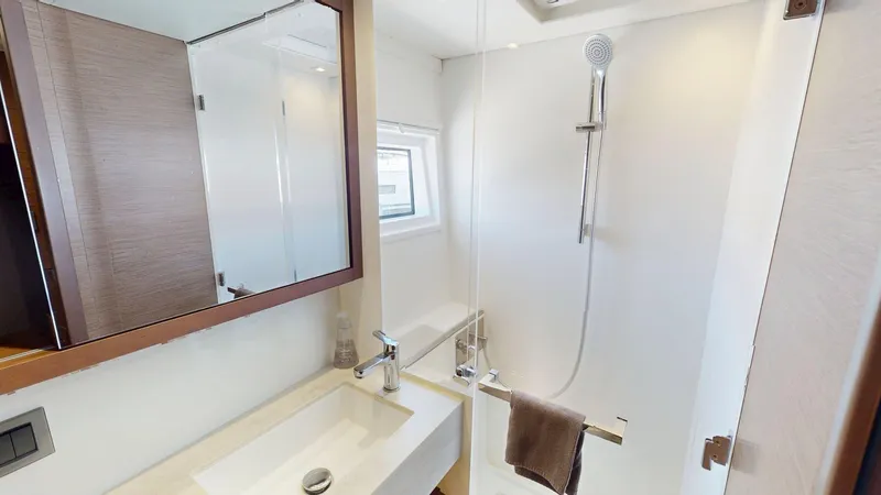 Slide: The Image of Modern bathroom interior on a 2020 Lagoon 46 yacht, featuring a sleek shower and sink. - 20