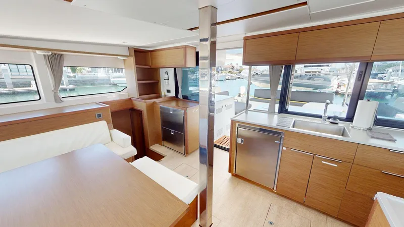 Slide: The Image of Interior of a 2020 Lagoon 46 catamaran with modern kitchen and dining area. - 6