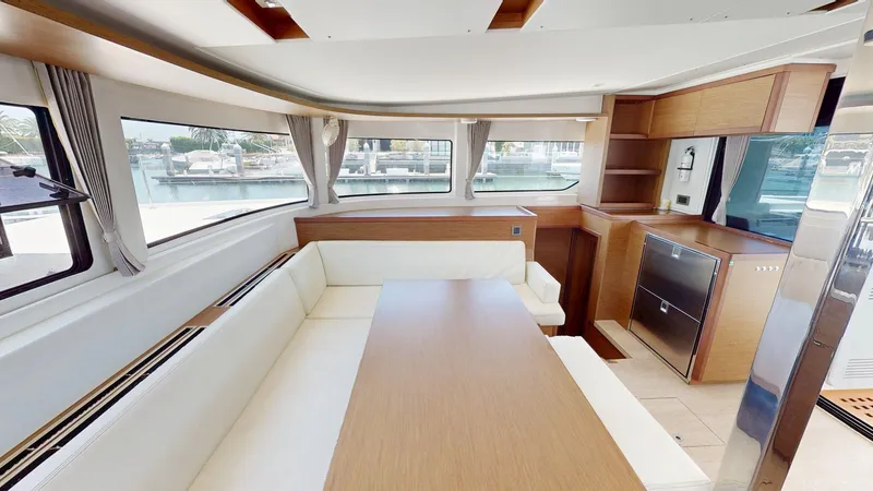 Slide: The Image of Interior of 2020 Lagoon 46 yacht with modern dining area and panoramic windows. - 7