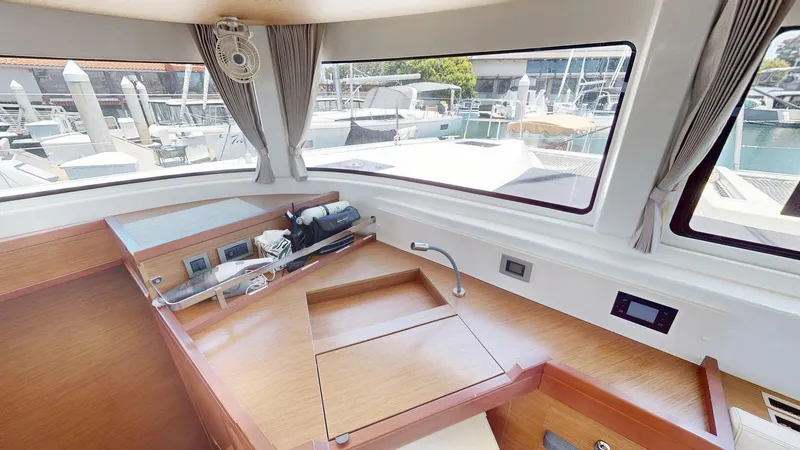 Slide: The Image of Interior of 2020 Lagoon 46 yacht with wooden cabinetry and marina view. - 8