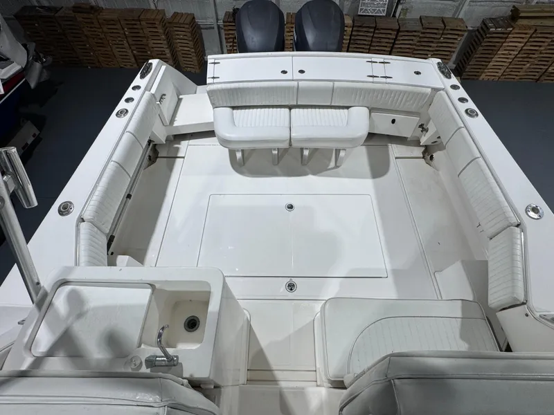 Slide: The Image of 2005 Stamas 310 Express boat interior with white seating and sink, viewed from above. - 11