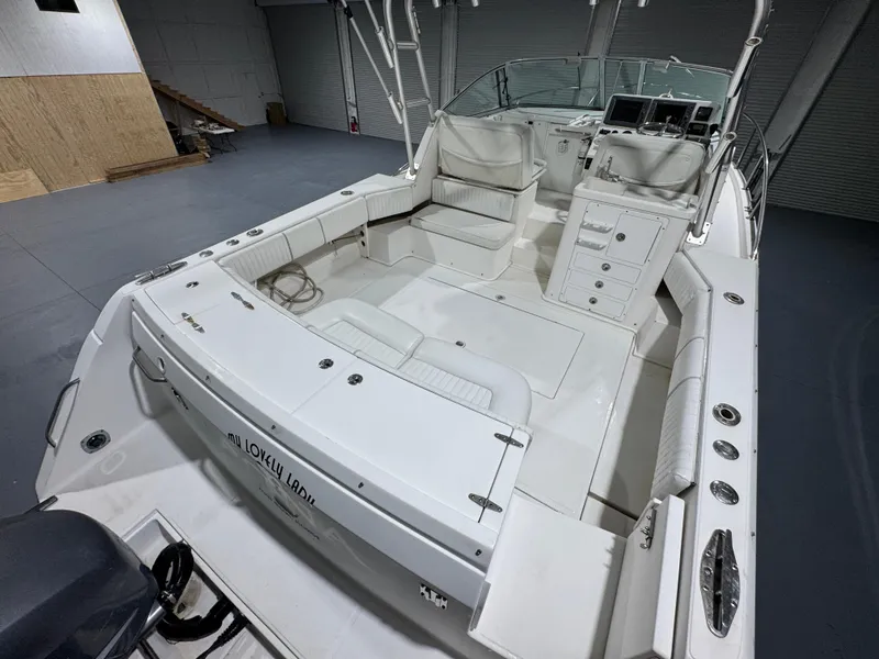 Slide: The Image of 2005 Stamas 310 Express boat interior with seating and control panel in a spacious garage. - 12