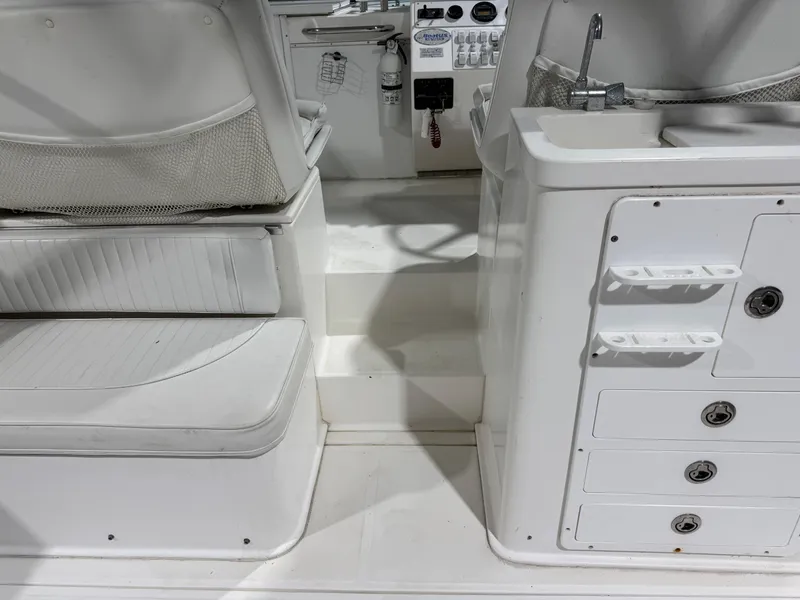 Slide: The Image of 2005 Stamas 310 Express boat interior with seating and storage compartments. - 16