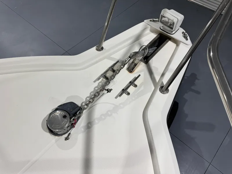 Slide: The Image of 2005 Stamas 310 Express boat anchor system with chain and cleat on deck. - 19