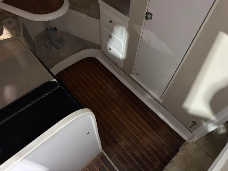 Slide: The Image of Interior of 2005 Stamas 310 Express boat with wood flooring and storage compartments. - 24
