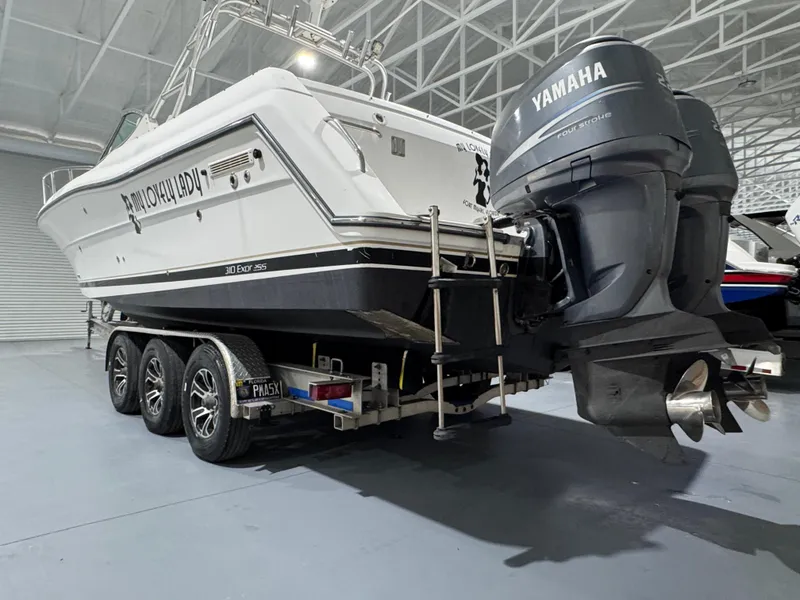 Slide: The Image of 2005 Stamas 310 Express boat on trailer with Yamaha outboard motors in a warehouse. - 4