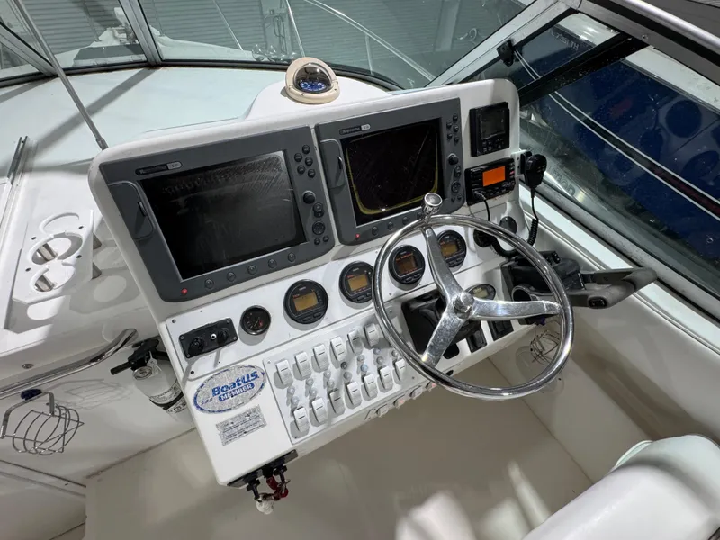 Slide: The Image of 2005 Stamas 310 Express boat dashboard with steering wheel and navigation instruments. - 7