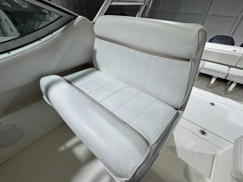 Slide: The Image of 2005 Stamas 310 Express boat interior with white cushioned seating. - 8