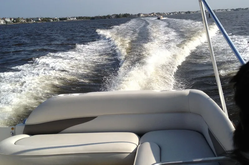 Slide: The Image of 2003 Crownline 262 CR boat cruising on open water, leaving a wake behind. - 16
