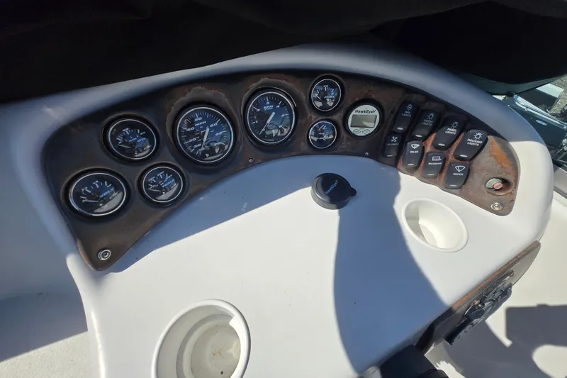 Slide: The Image of Dashboard of a 2003 Crownline 262 CR boat with gauges and controls. - 19