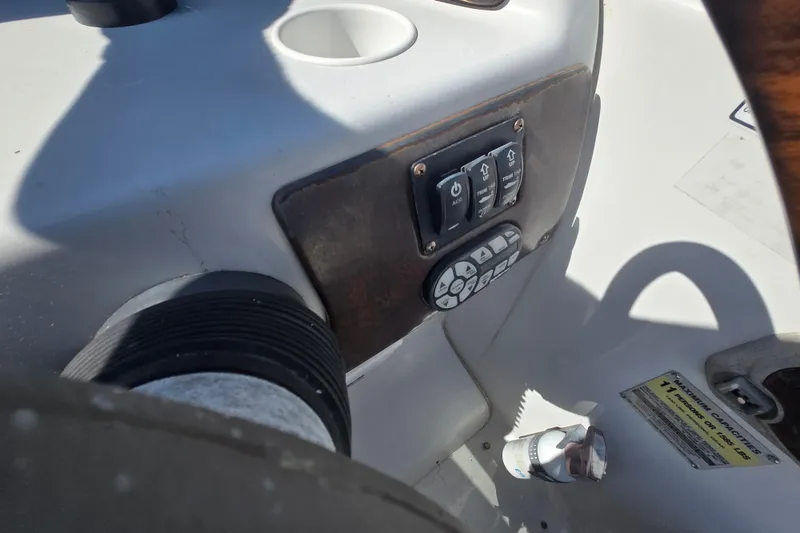 Slide: The Image of Control panel of a 2003 Crownline 262 CR boat with switches and buttons. - 20