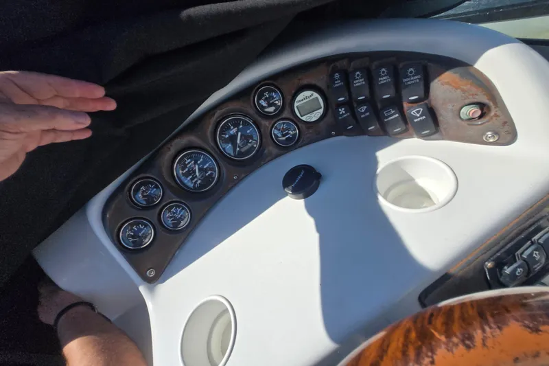 Slide: The Image of Dashboard of a 2003 Crownline 262 CR boat with gauges and controls. - 21