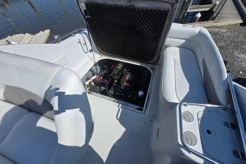 Slide: The Image of 2003 Crownline 262 CR boat engine compartment with open hatch, dockside view. - 22