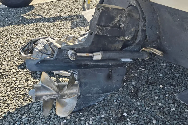 Slide: The Image of Propeller and drive system of a 2003 Crownline 262 CR boat on gravel surface. - 23