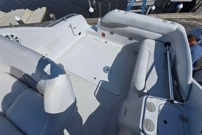 Slide: The Image of 2003 Crownline 262 CR boat interior with white seating and cup holders. - 27