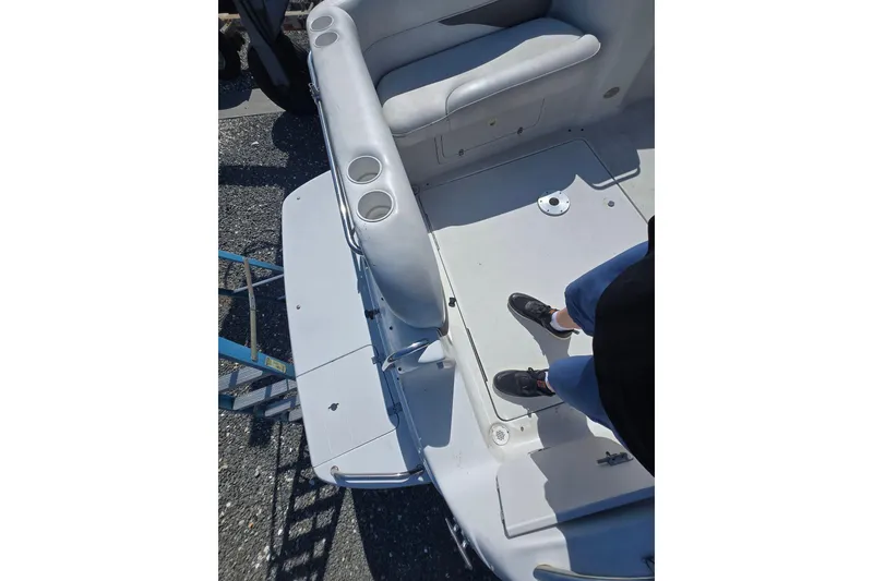 Slide: The Image of 2003 Crownline 262 CR boat interior with seating and cup holders. - 30