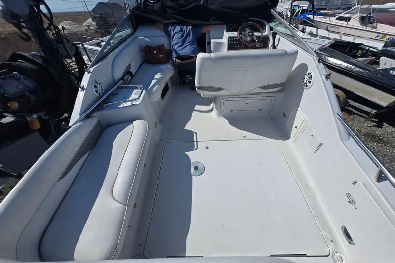 Slide: The Image of 2003 Crownline 262 CR boat interior with white seating and steering area. - 31