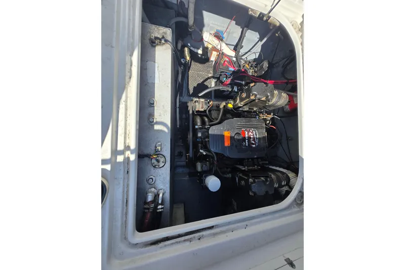 Slide: The Image of Engine compartment of a 2003 Crownline 262 CR boat, showing mechanical components. - 32