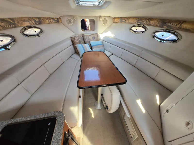 Slide: The Image of Interior of a 2003 Crownline 262 CR boat with seating and table. - 4