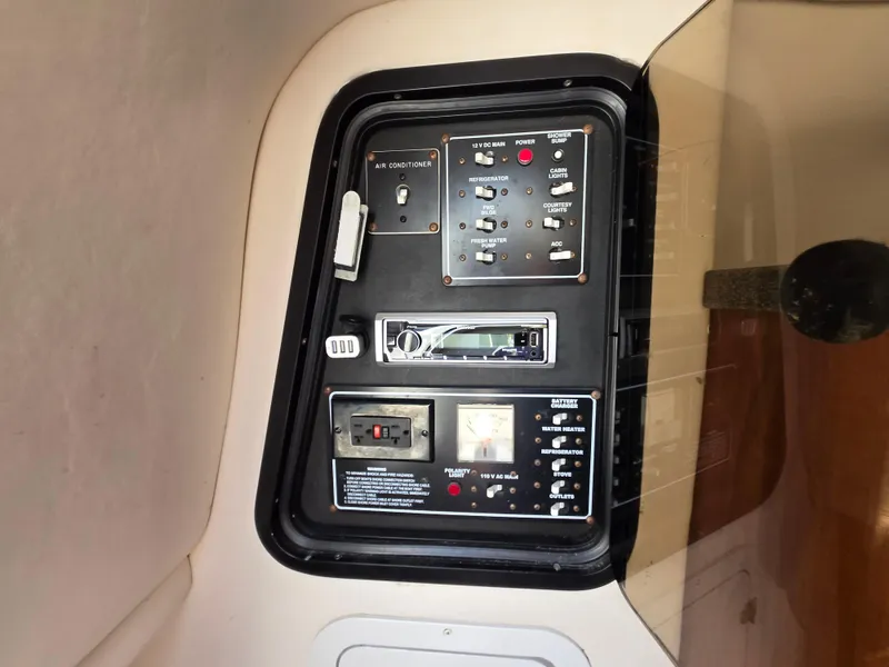 Slide: The Image of Control panel of a 2003 Crownline 262 CR boat, featuring various switches and gauges. - 6