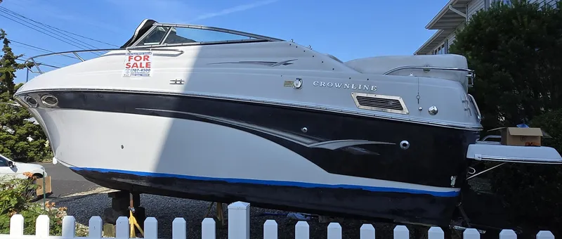 Slide: The Image of 2003 Crownline 262 CR boat for sale, displayed outdoors with a "For Sale" sign. - 8