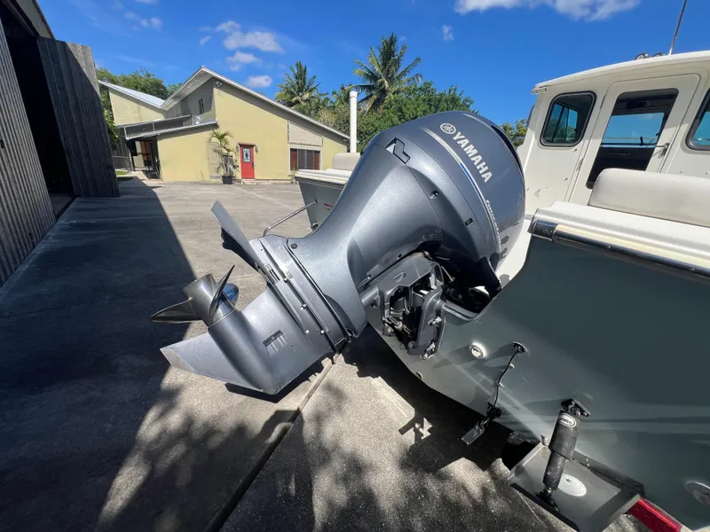 Slide: The Image of Parker 2120 boat with Yamaha outboard motor, parked near a house, 2021 model. - 12