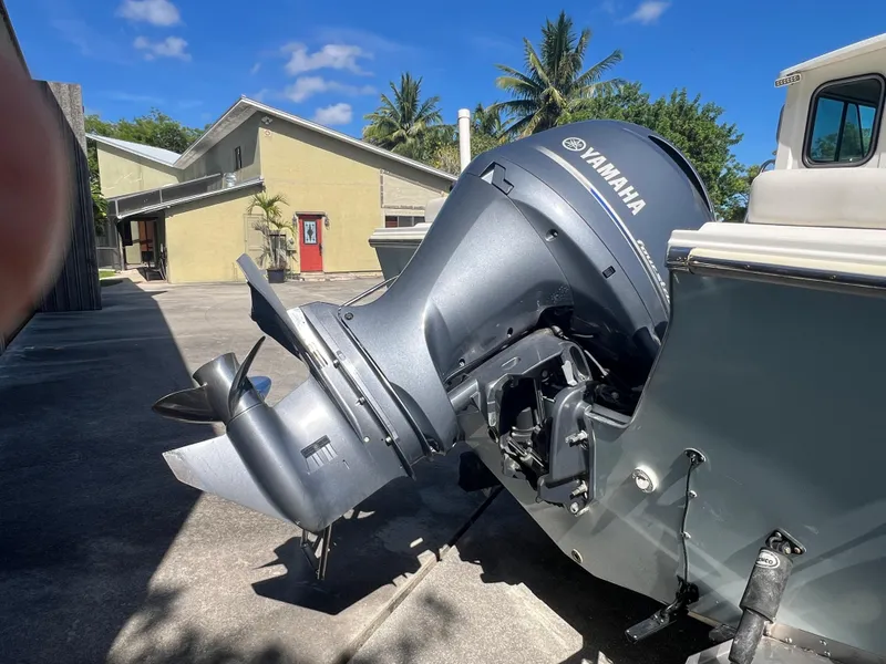 Slide: The Image of Yamaha outboard motor on Parker 2120 boat, 2021 model, in sunny driveway setting. - 14