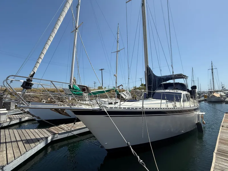 The Image of 1985 Nauticat 43 sailboat docked at marina under clear blue sky. - 0