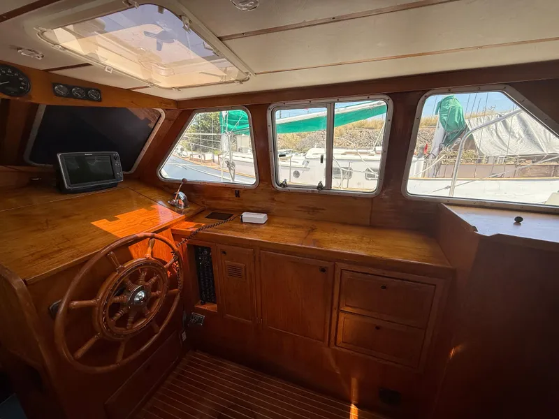 Slide: The Image of Interior of 1985 Nauticat 43 sailboat with wooden helm and navigation equipment. - 19