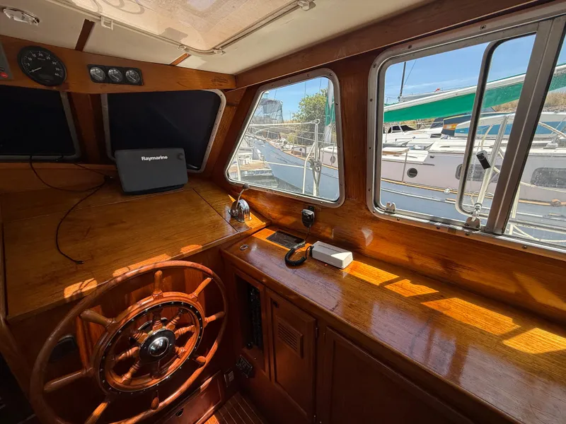 Slide: The Image of Interior of 1985 Nauticat 43 sailboat with wooden helm and navigation equipment. - 20