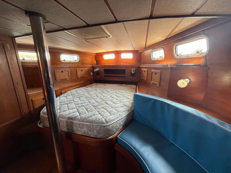 Slide: The Image of Interior of 1985 Nauticat 43 sailboat cabin with bed and seating area. - 22
