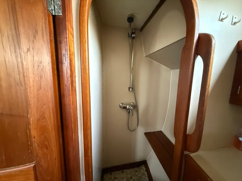 Slide: The Image of Shower area in 1985 Nauticat 43 sailboat with wooden accents and compact design. - 24