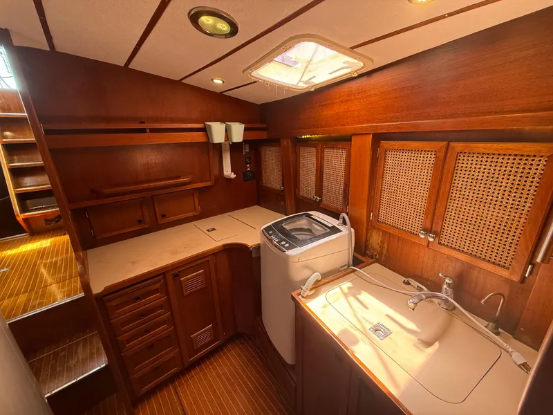 Slide: The Image of Interior of 1985 Nauticat 43 yacht with wooden cabinetry and washing machine. - 30