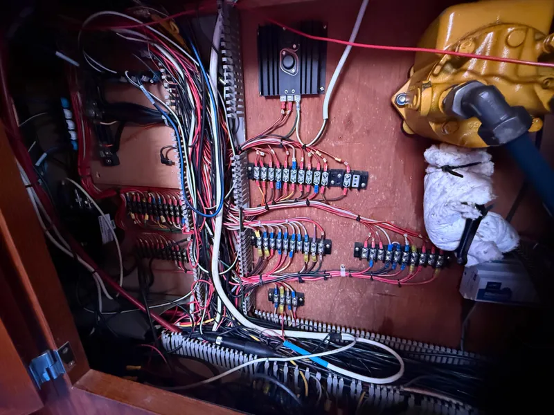 Slide: The Image of Electrical wiring system inside a 1985 Nauticat 43 boat, showcasing complex cable arrangement. - 33