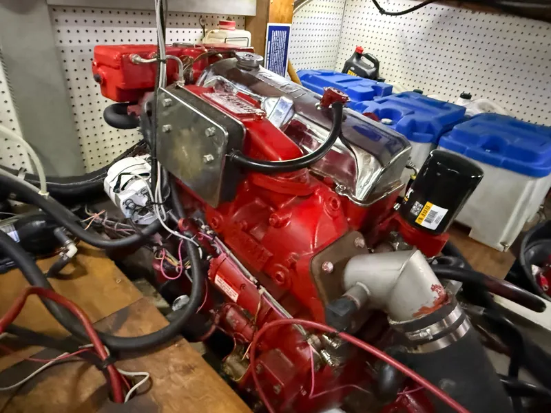 Slide: The Image of Red engine of a 1985 Nauticat 43 sailboat, surrounded by cables and equipment. - 36