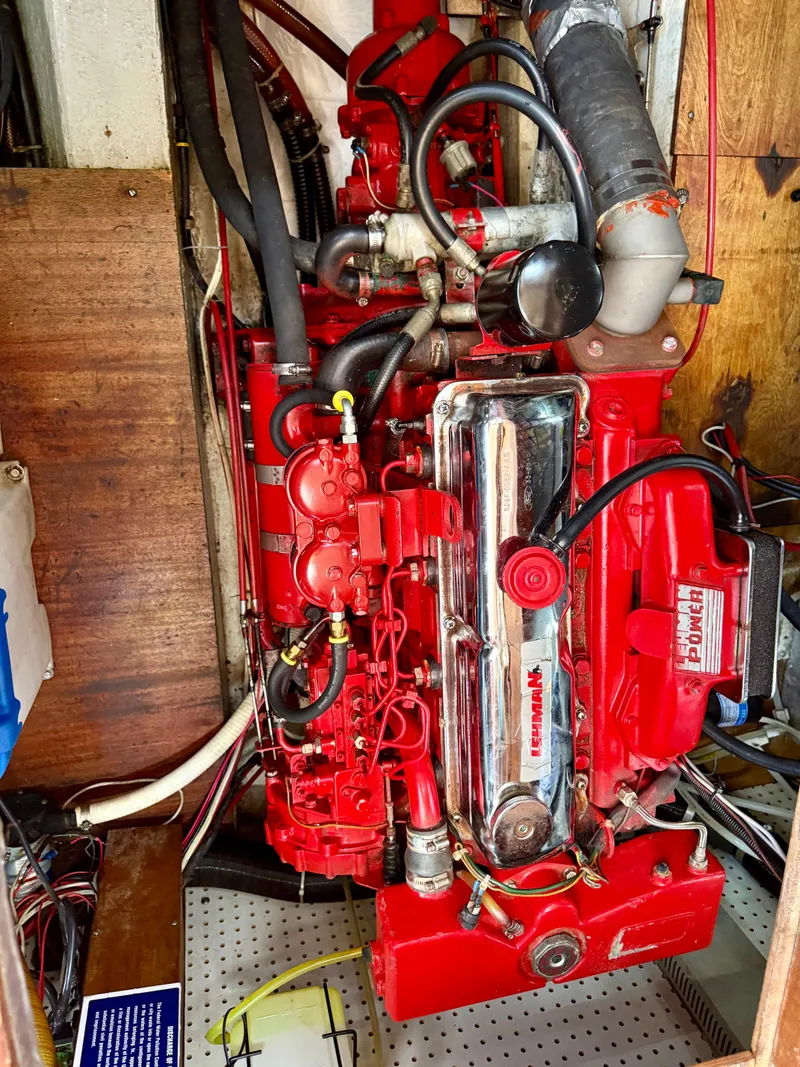 Slide: The Image of Red engine of a 1985 Nauticat 43 sailboat, showcasing detailed mechanical components. - 37